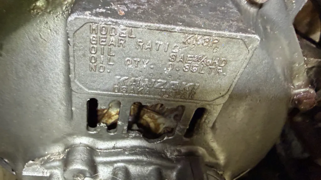 A cracked marine transmission housing below the maker data plate