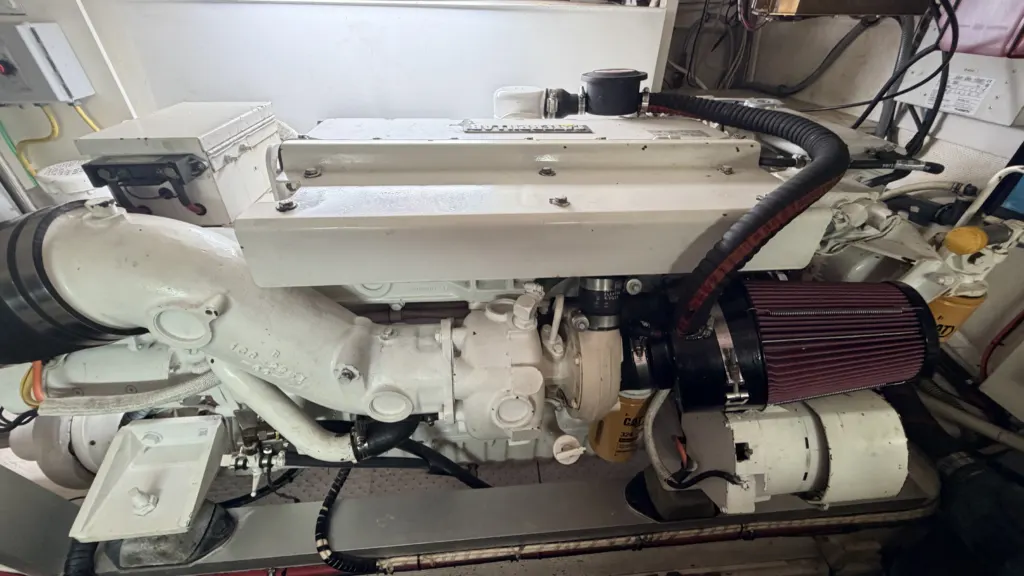 A marine diesel engine in an engine room, seen from the outboard side